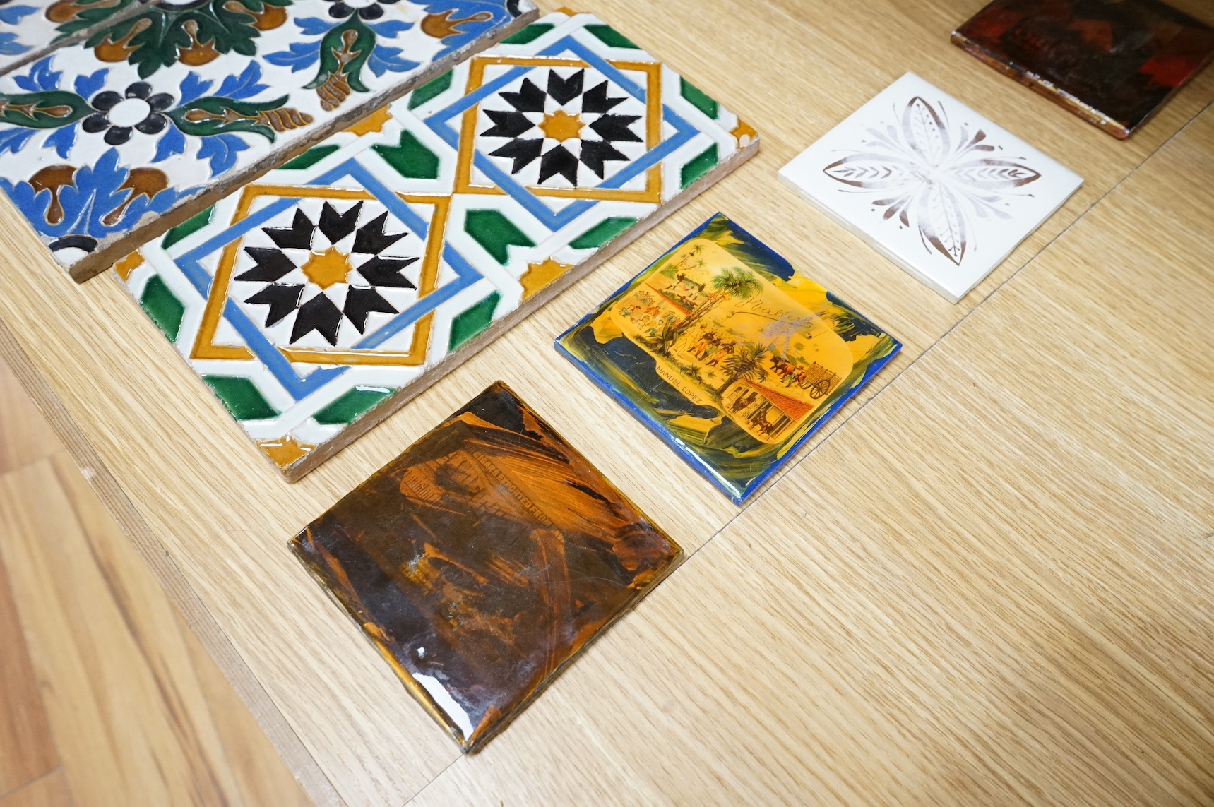 A collection of European tiles, to include a German rampant lion example, dishes and a Belgian bowl, largest 27cm in diameter. Condition - varies